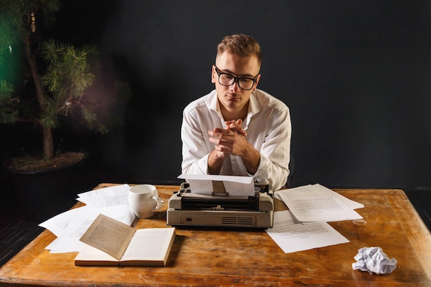 A person sitting at a desk, sifting through old documents and using a magnifying glass to examine them closely. The scene conveys a sense of detailed investigation and historical review, emphasizing the process of uncovering forgotten financial records.