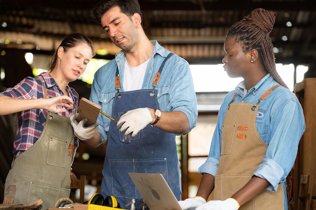 A group of apprentices working alongside experienced tradespeople on a construction site, demonstrating hands-on skills and teamwork. The image highlights the practical nature of apprenticeship programs.